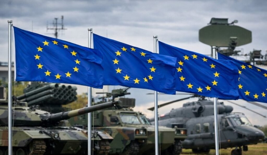 Ευρωπαϊκή Αμυντική Αυτονομία: Τι Σημαίνει για την Ελλάδα στη Νέα Αρχιτεκτονική Ασφαλείας Σημαίες της Ευρωπαϊκής Ένωσης με στρατιωτικό φόντο